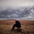 "A Kurdish man sits at the border area close to the southeastern village of Mursitpinar, in the Sanliurfa province, opposite the Syrian town of Kobane, also known as Ain al-Arab, where heavy fighting between Islamic State militants and Kurdish fighters is taking place, on October 16, 2014. Turkey's ruling party said it was optimistic about the prospects for the peace process with Kurdish rebels after a spate of violence raised concern about its viability.  AFP PHOTO / ARIS MESSINIS/AFP/Getty Images"